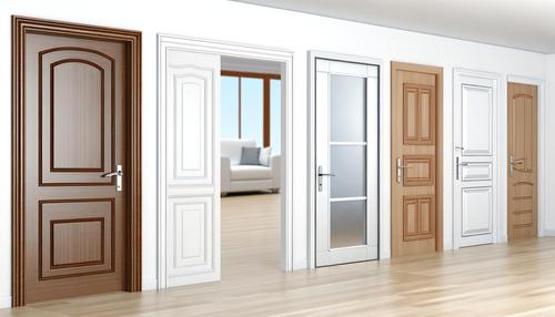 A room with six different styles of closed and partially open doors, showcasing various designs and colors.