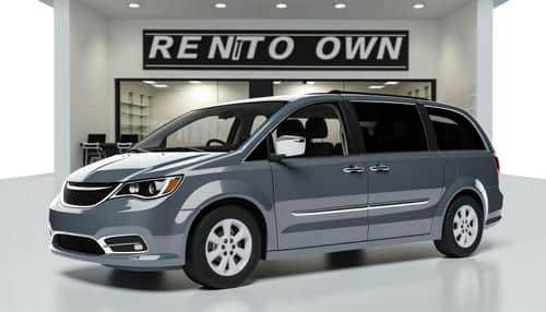 A gray minivan is parked indoors at a dealership with a "Rent to Own" sign in the background.