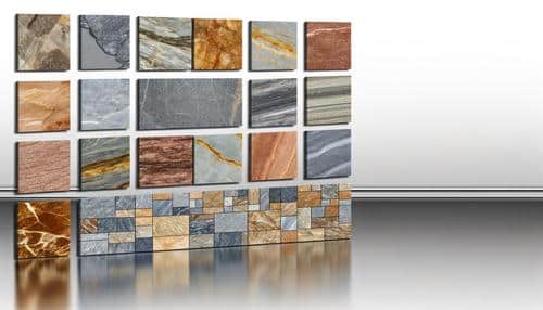 Various stone tiles in different colors and textures are displayed on a reflective surface.