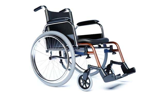 A modern wheelchair with metal frame, cushioned seat, and large rear wheels.