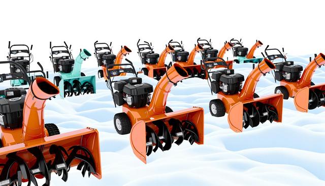 Multiple orange snow blowers on a snowy surface.