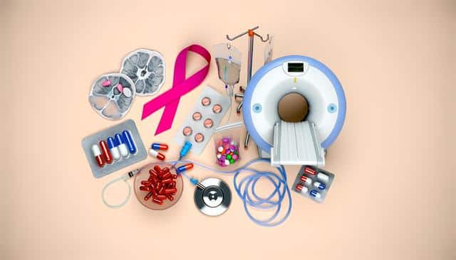 Medical equipment and pills, MRI scanner, pink ribbon, IV bags, tablets, and stethoscope on a beige background.