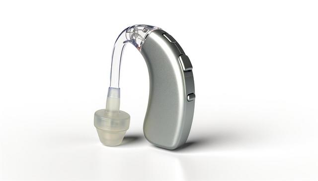 A gray behind-the-ear hearing aid with a transparent tube and beige earpiece.