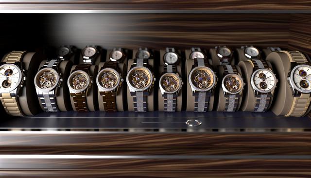 A collection of various wristwatches with different bands and dials displayed on a wooden surface.