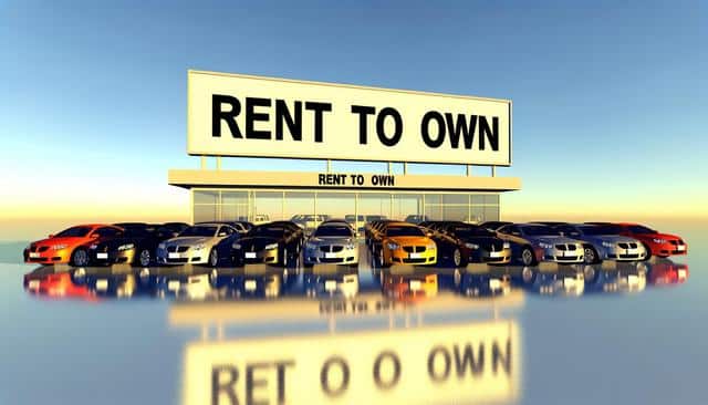 A row of colorful cars parked in front of a building with a large "Rent to Own" sign.