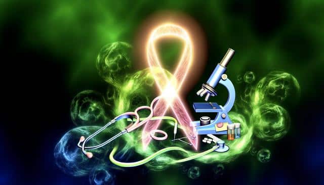 A glowing pink ribbon near a blue microscope, stethoscope, and pills on a green and black background.