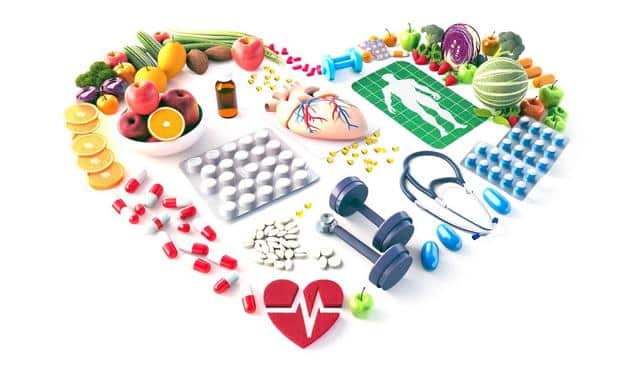 Heart-shaped collage of fruits, pills, dumbbells, stethoscope, and heart monitor symbol.