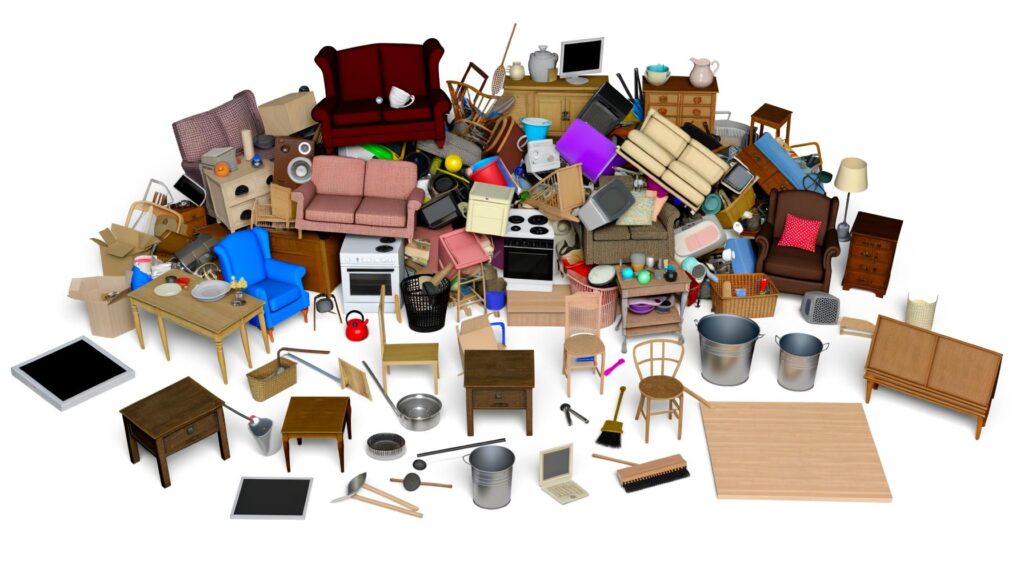 A large pile of assorted household items, including furniture, appliances, and boxes, arranged chaotically.