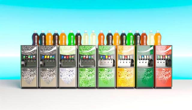 A row of soda fountains with colorful beverage bottles on top, set against a bright blue background.