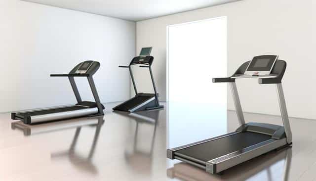 Three treadmills in a bright, modern room with wooden floors.