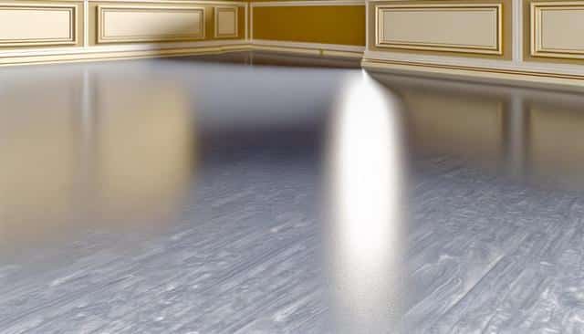 A polished wooden floor with gold-trimmed beige walls reflected on its surface.